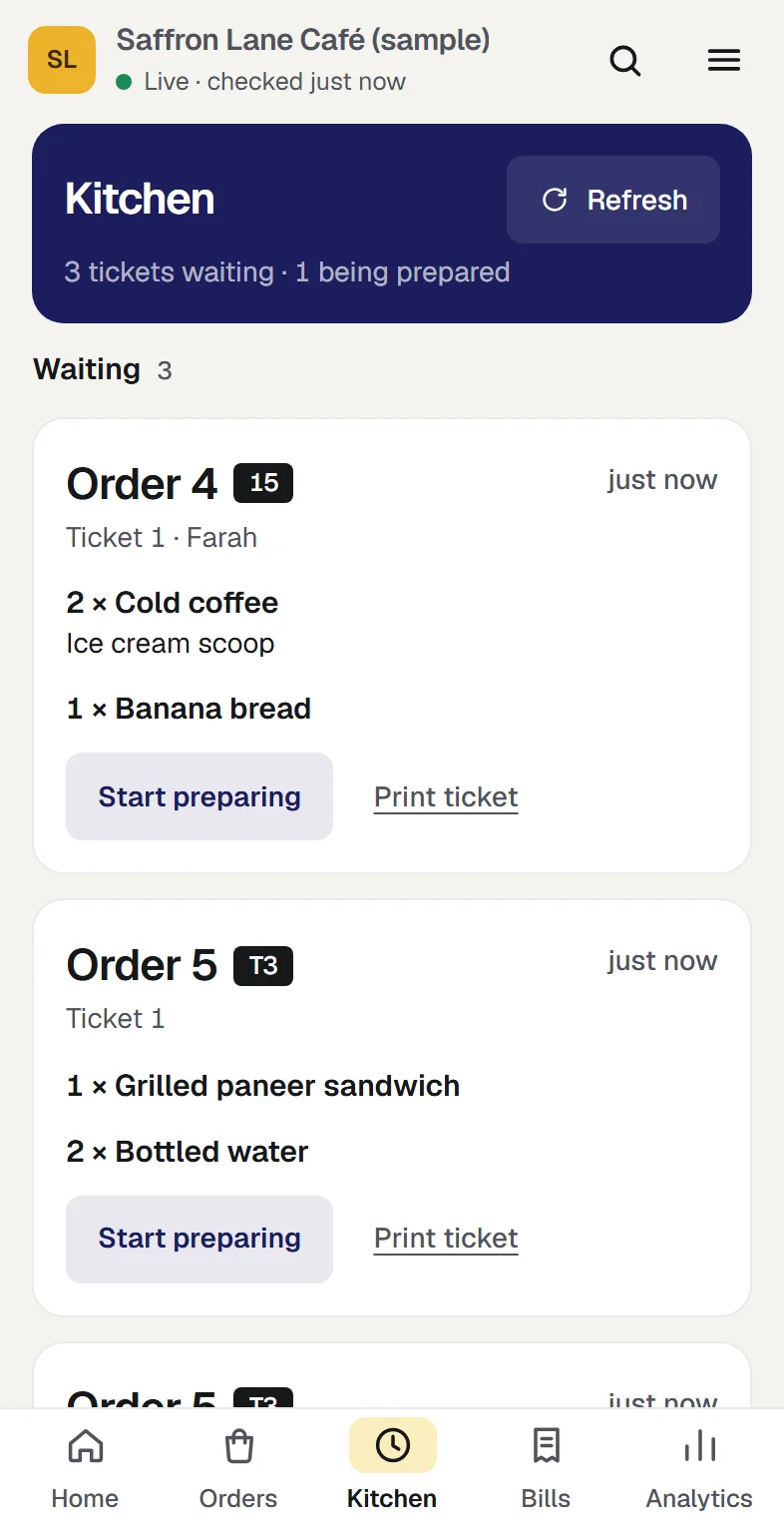 The kitchen queue at the sample café in three columns: three tickets waiting, one being prepared and two ready, with a second ticket for order 5 that holds only the oat cookie added to it. At phone width.