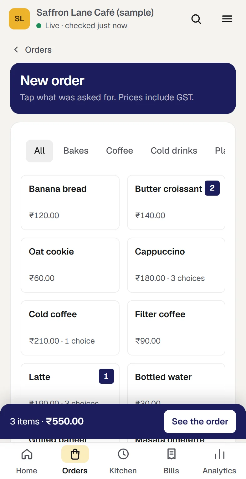 A new order at the sample café: the menu by part, a latte with an extra shot and oat milk and two butter croissants in the order, the name Ananya, token 14, and a total of ₹550.00 that includes ₹26.20 GST. At phone width.