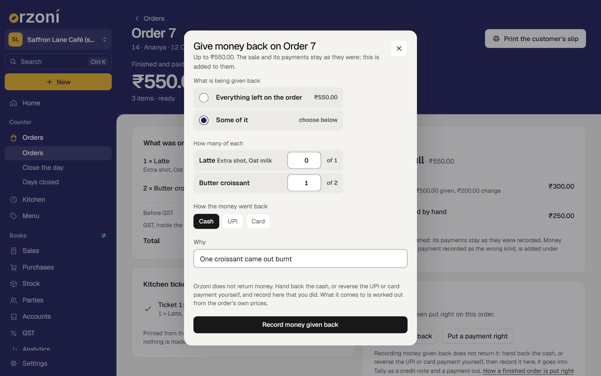 The sheet Give money back on Order 7, for the made-up Saffron Lane Café (sample). Up to ₹550.00, and the sale and its payments stay as they were. Under What is being given back, Some of it is chosen, under Everything left on the order, ₹550.00. Under How many of each: Latte, with Extra shot and Oat milk, 0 of 1, and Butter croissant, 1 of 2. Under How the money went back, Cash is chosen beside UPI and Card. Why reads One croissant came out burnt. A note says Orzoni does not return money: hand back the cash, or reverse the UPI or card payment yourself, and record here that you did. The button reads Record money given back.